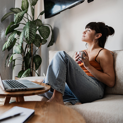 Cozy living room with laptop and plants
